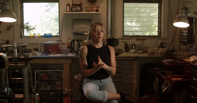 a woman sitting in a chair in a kitchen