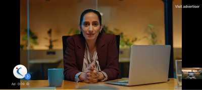 a woman sitting in front of a laptop computer