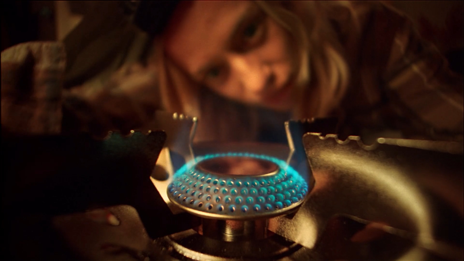 a close up of a stove with a person in the background