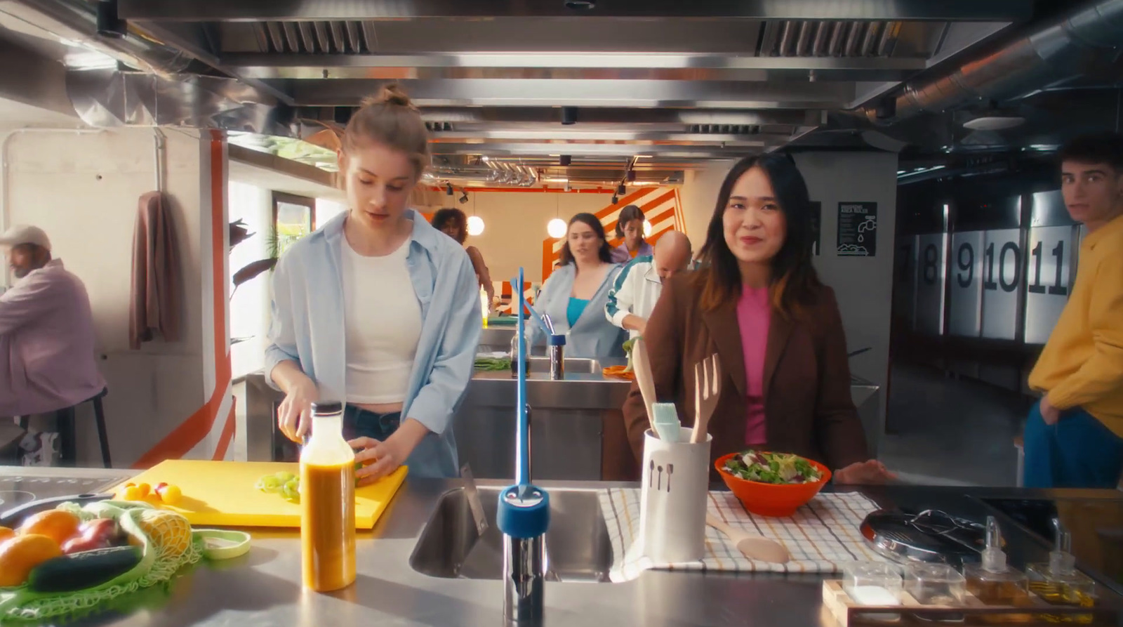 a group of people in a kitchen preparing food