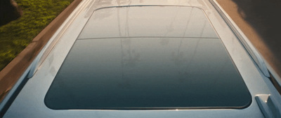 a blue car parked on the side of a road