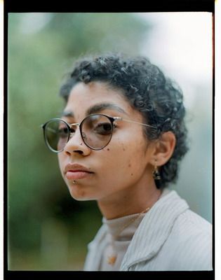 a woman wearing glasses and a t-shirt