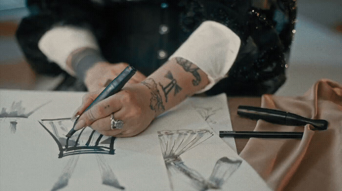 a woman is drawing on a piece of paper