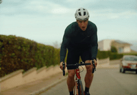 a man riding a bike down a street