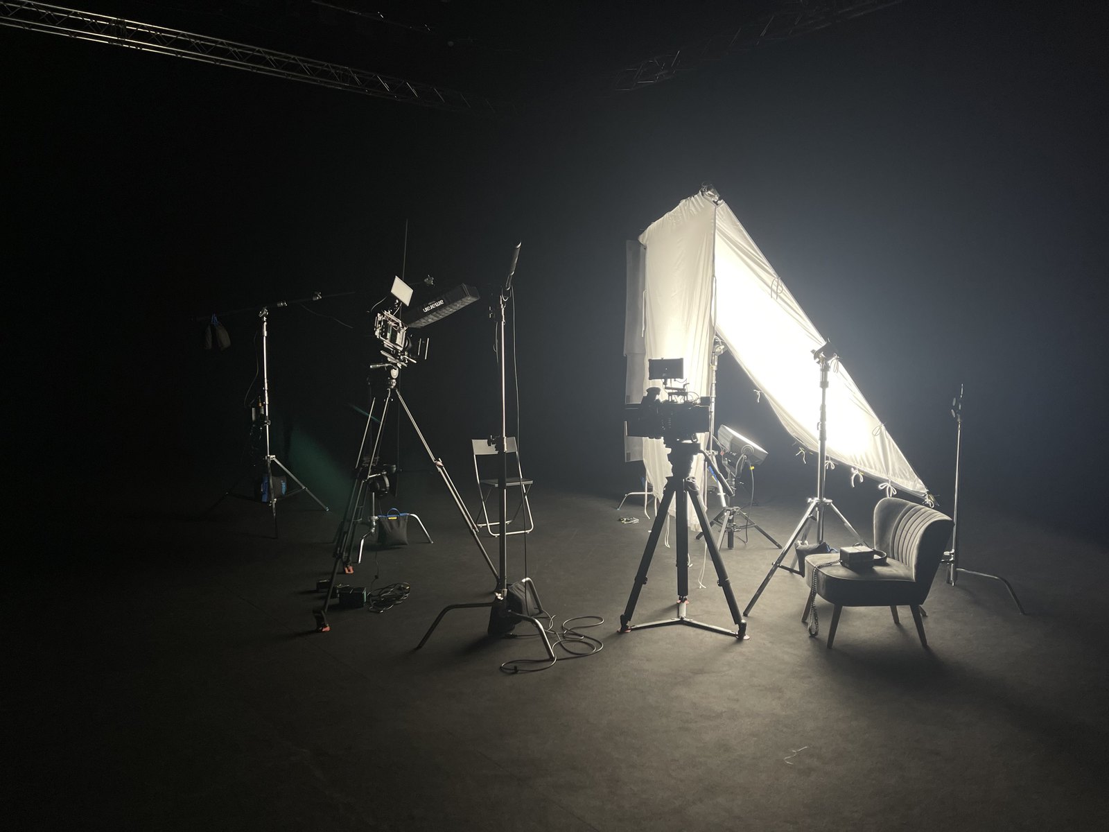 a photo studio with a camera and a tripod