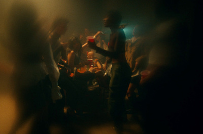 a group of people standing around in a dark room