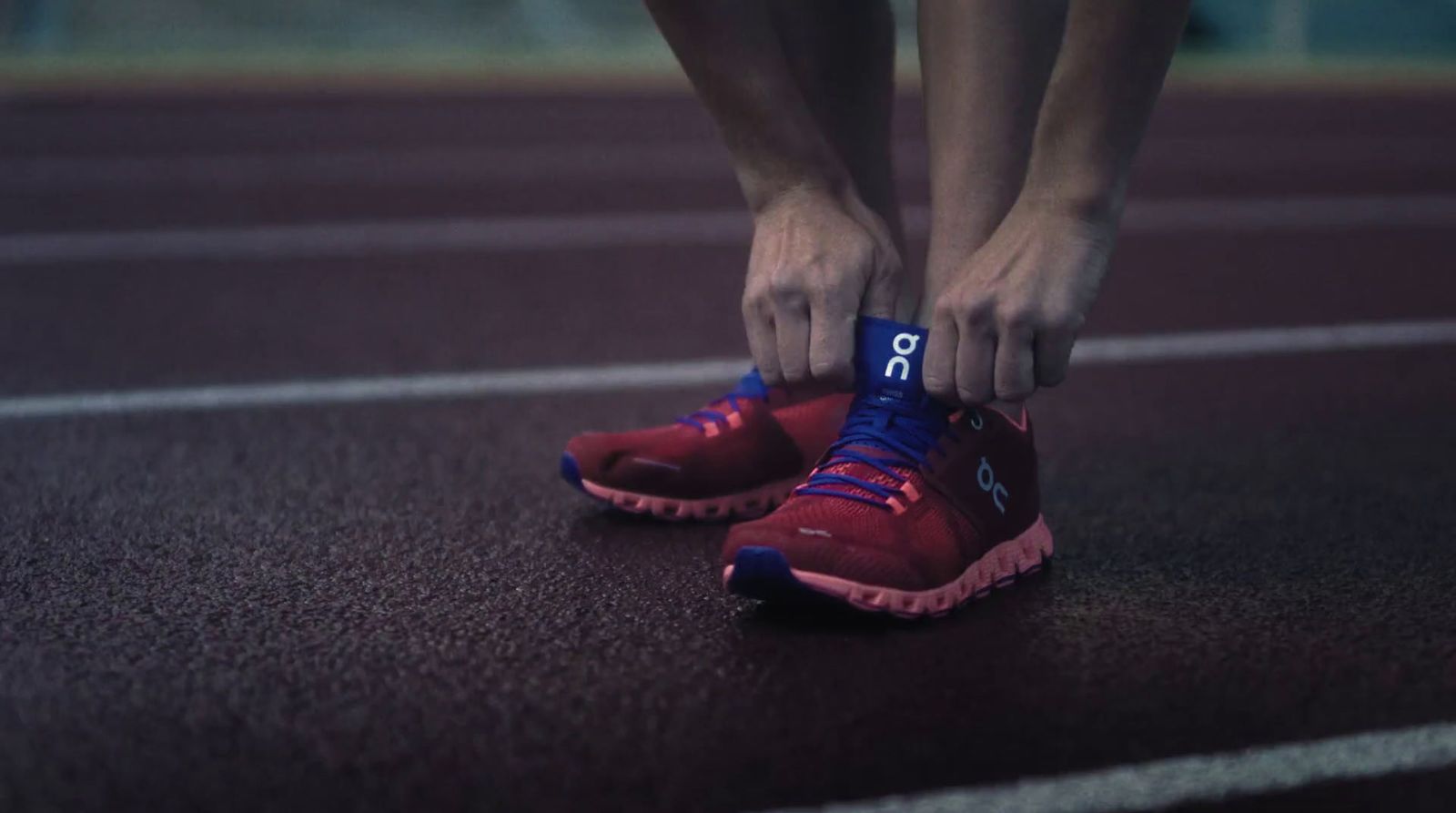 a person tying their shoes on a track