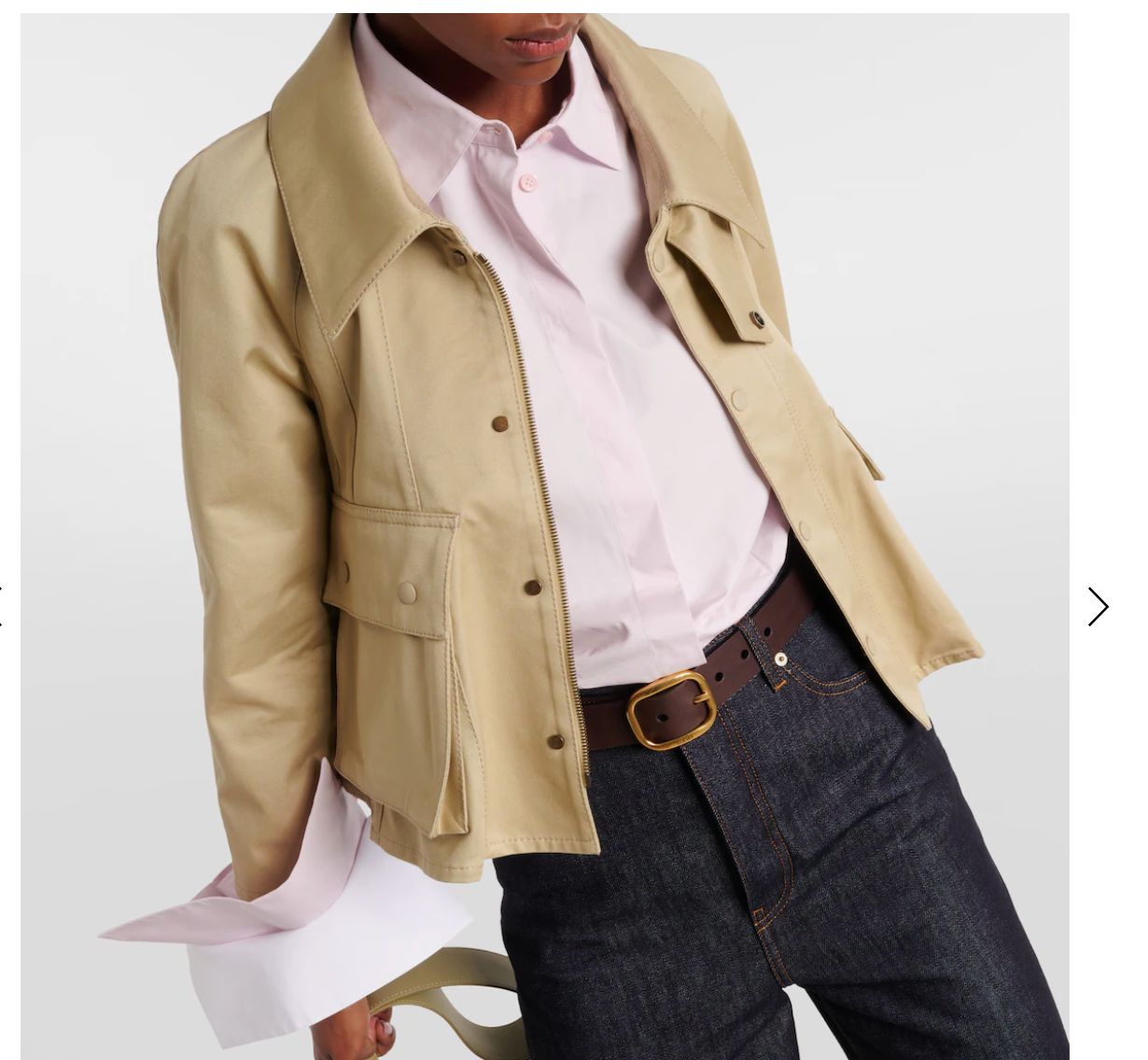 a woman in a white shirt and a tan jacket