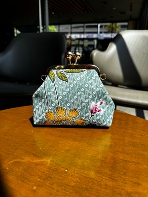 a purse sitting on top of a wooden table