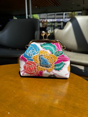 a purse sitting on top of a wooden table