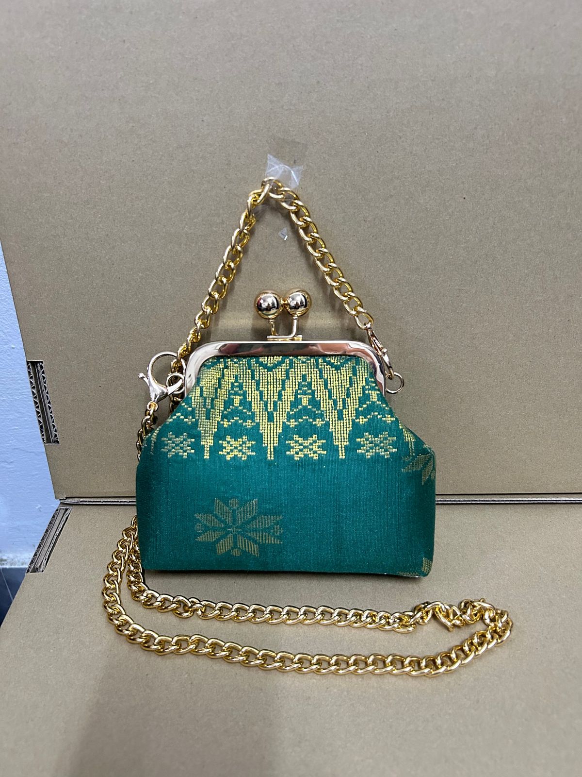a purse with a chain hanging off of it