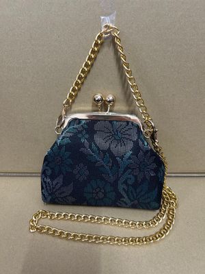 a blue purse sitting on top of a table