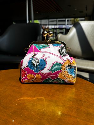 a purse sitting on top of a wooden table