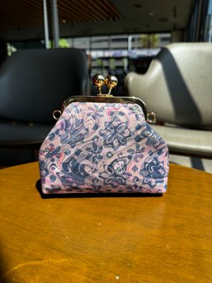 a purse sitting on top of a wooden table
