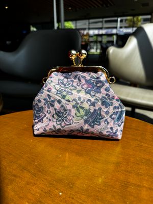 a purse sitting on top of a wooden table