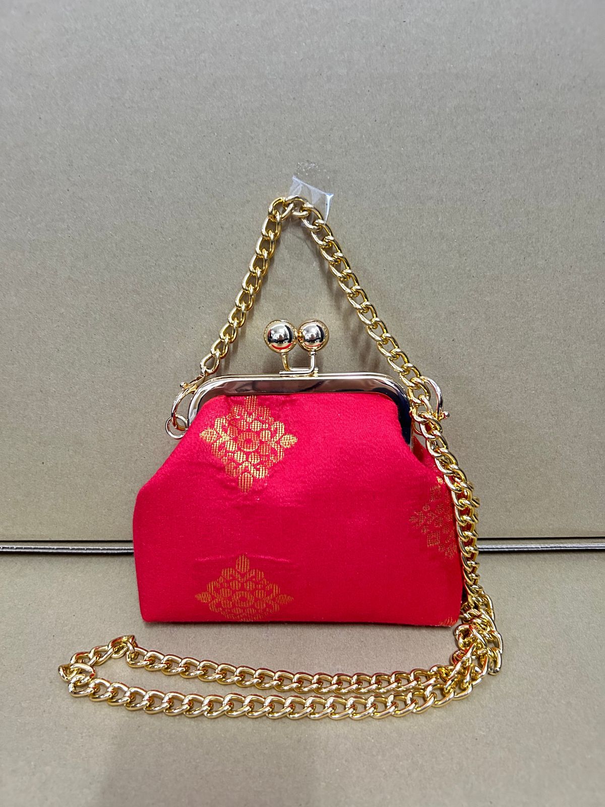 a pink purse sitting on top of a counter