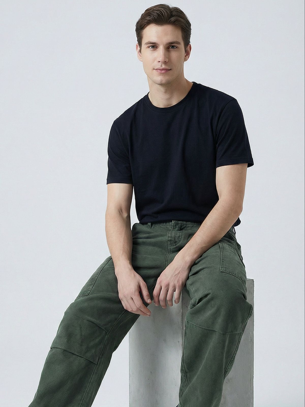 a man sitting on top of a cement block