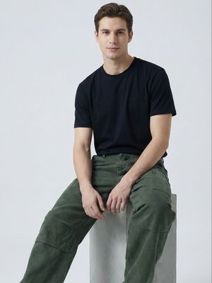 a man sitting on top of a cement block
