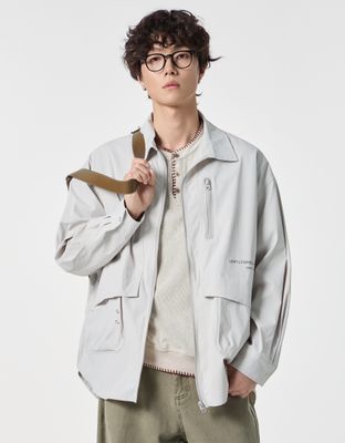 a man wearing a white jacket and glasses
