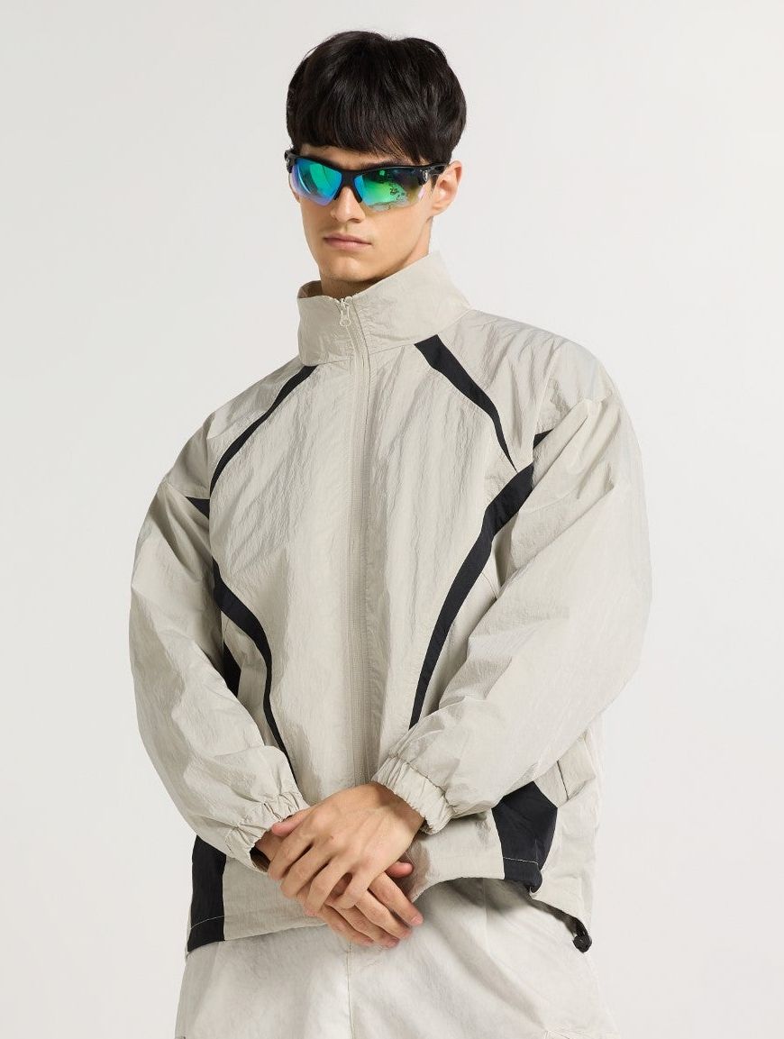 a man wearing a white jacket and sunglasses
