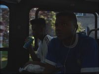 a group of young men riding on the back of a bus