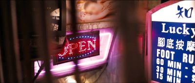 a neon sign that reads jaden next to a clock