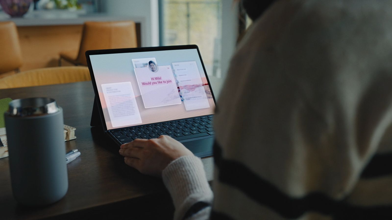 a person sitting at a table with a laptop