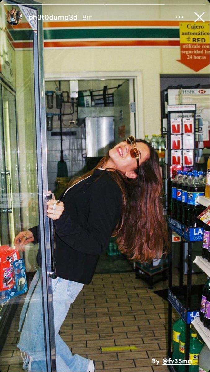 a woman leaning against a glass door in a store