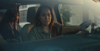 a woman sitting in the passenger seat of a car