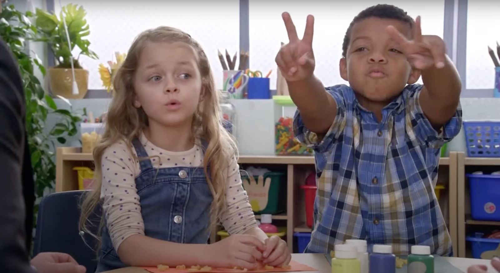 a couple of kids that are sitting at a table