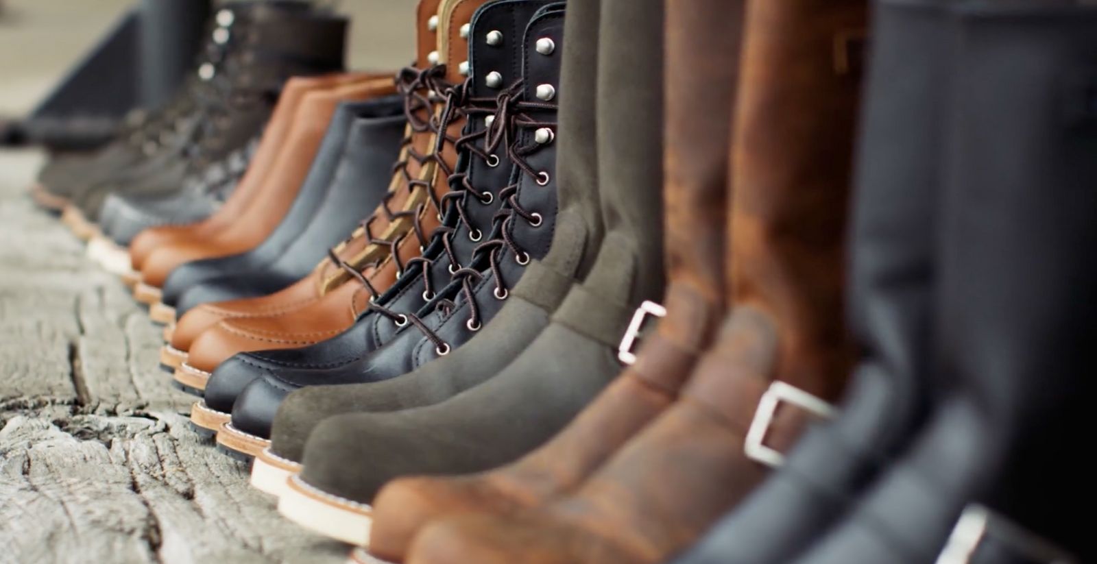 a row of boots lined up against a wall