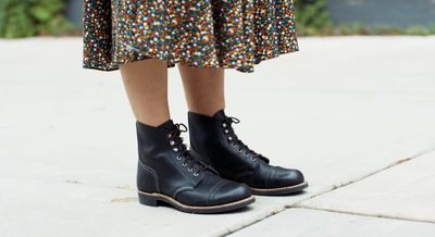 a close up of a person wearing black boots