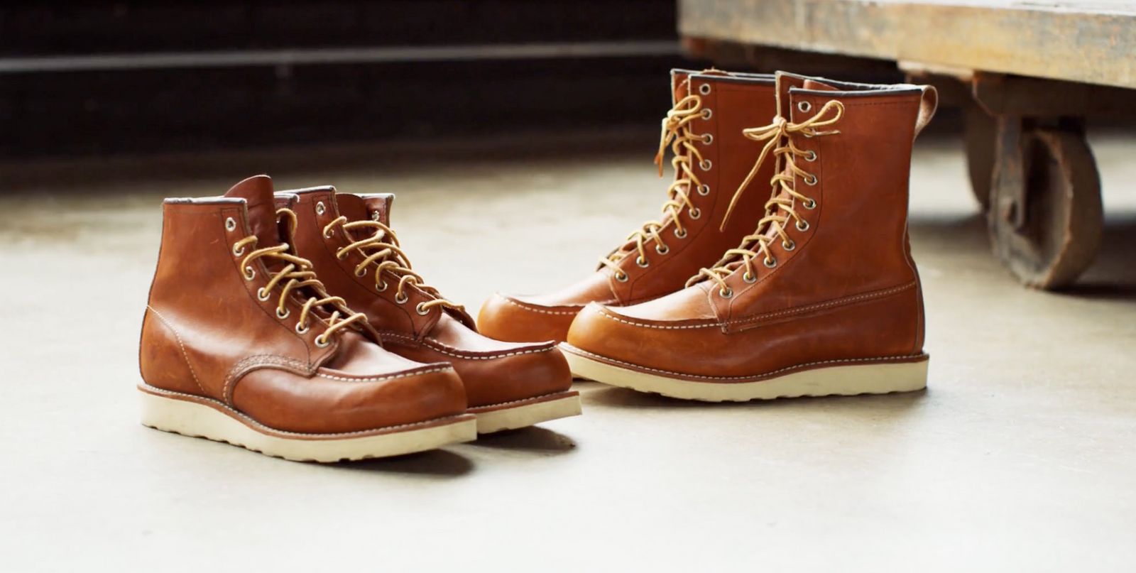 a pair of brown boots sitting on top of a cement floor