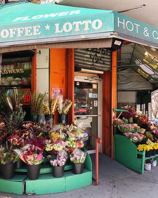 a flower shop with a lot of flowers in front of it