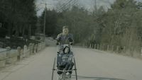 a woman pushing a child in a stroller