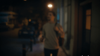 a man walking down a street at night