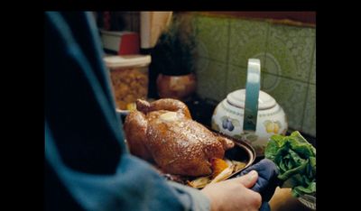 a person holding a plate of food with a turkey on it