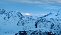 a man standing on top of a snow covered mountain