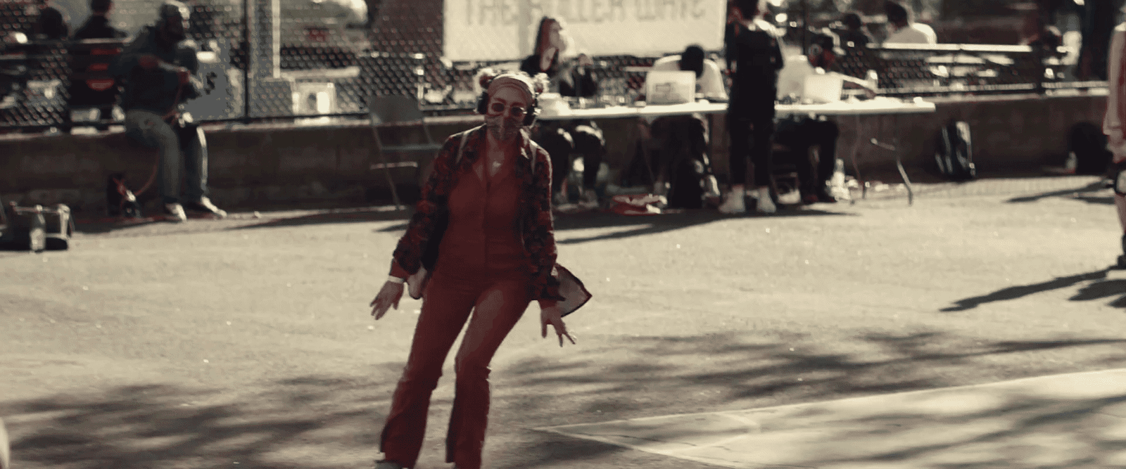 a woman in a red suit walking down a street