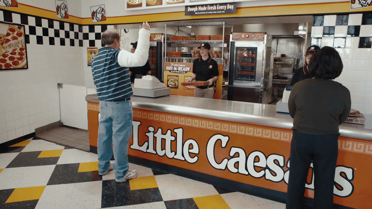 a couple of people that are standing in front of a counter