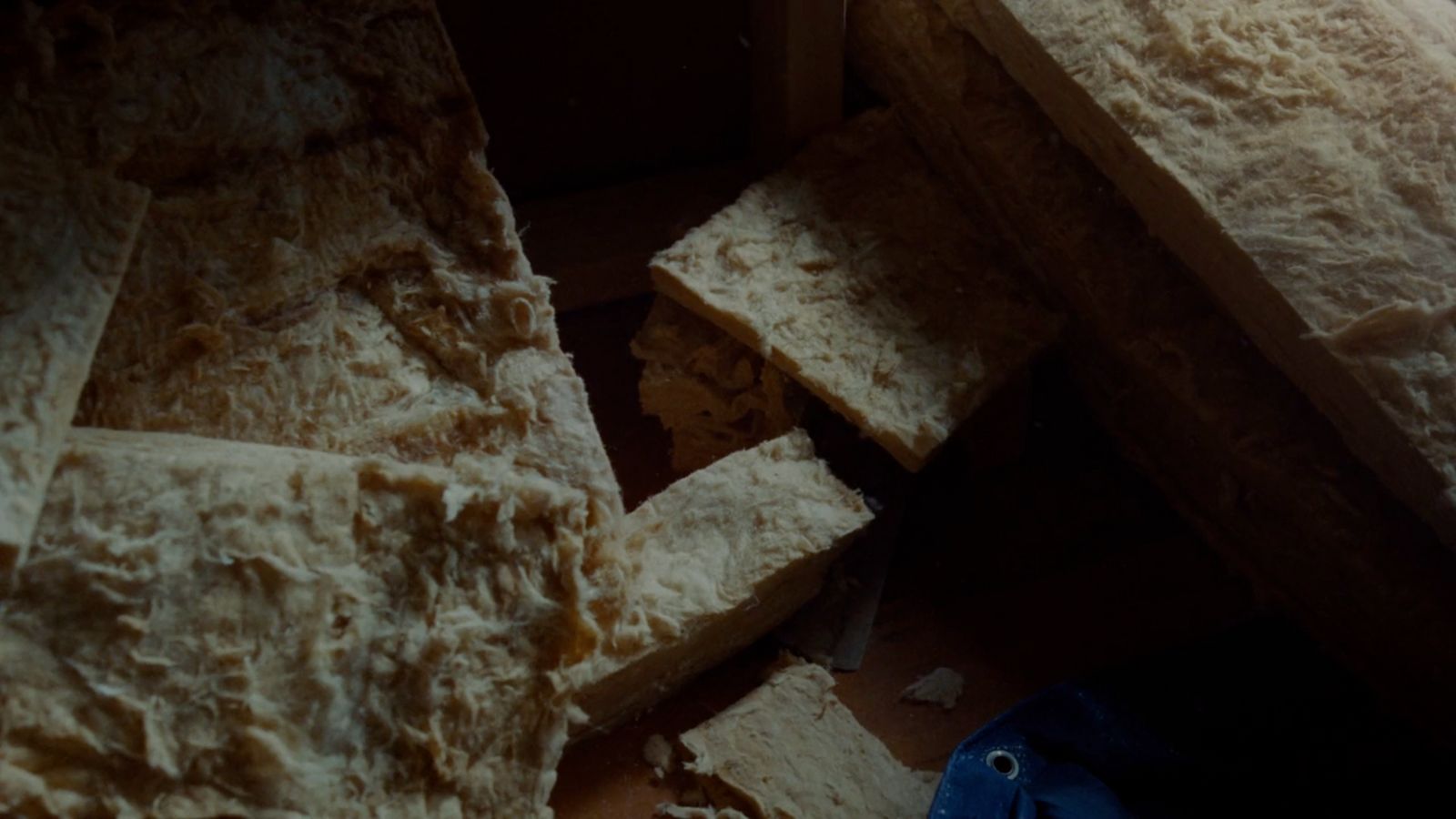 a pile of bread sitting on top of a wooden table