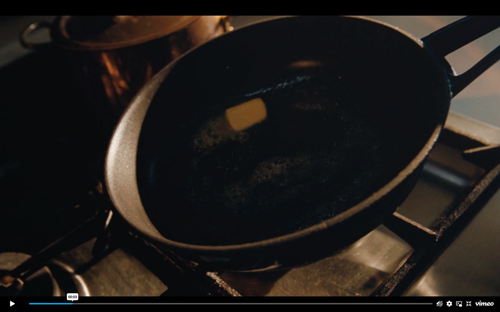 a frying pan with a butter stick in it