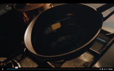 a frying pan with a butter stick in it