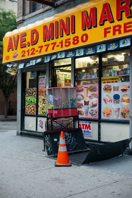 a store front with a cone on the sidewalk in front of it