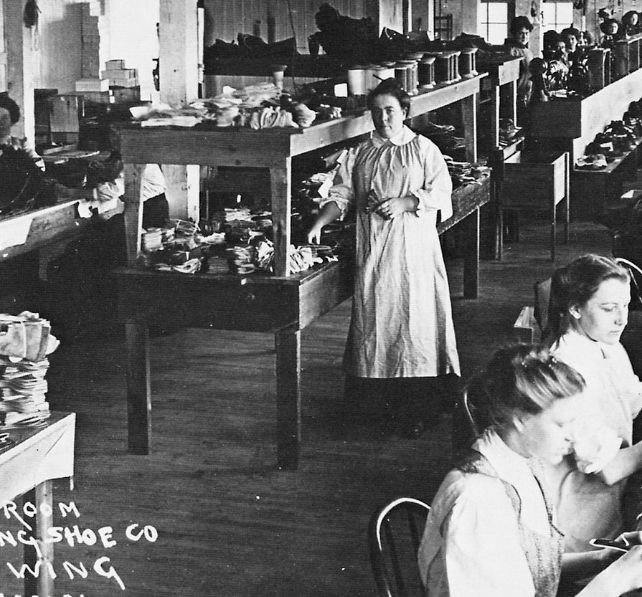 a black and white photo of people in a room