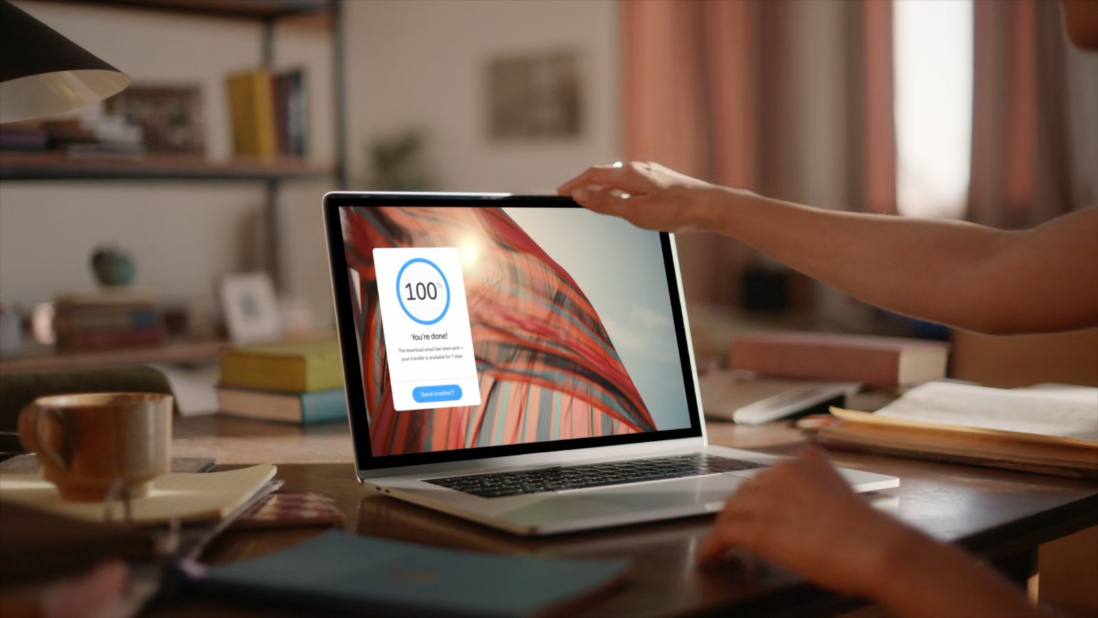 a person sitting at a desk with a laptop