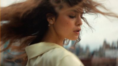 a woman with her hair blowing in the wind