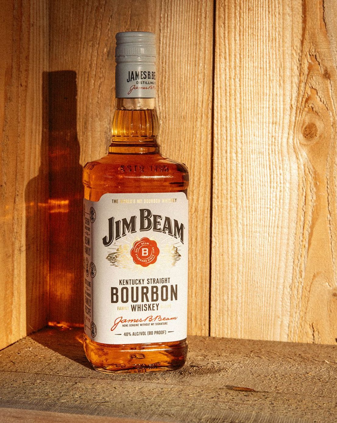 a bottle of bourbon sitting on top of a wooden shelf