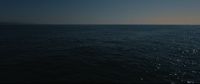 a large body of water under a blue sky