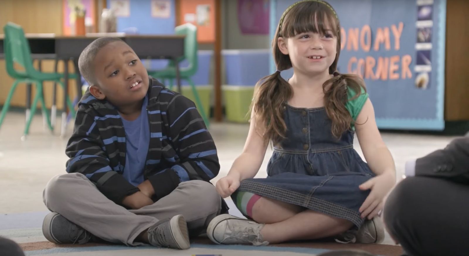 a couple of kids sitting on the floor